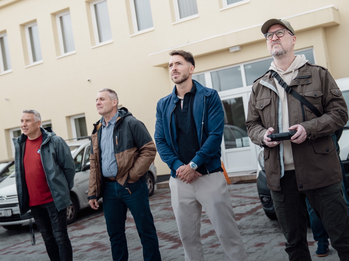 Résztvevők a terepen figyelik a drónt